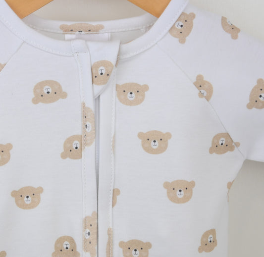 White baby onesie with bear pattern on a hanger
