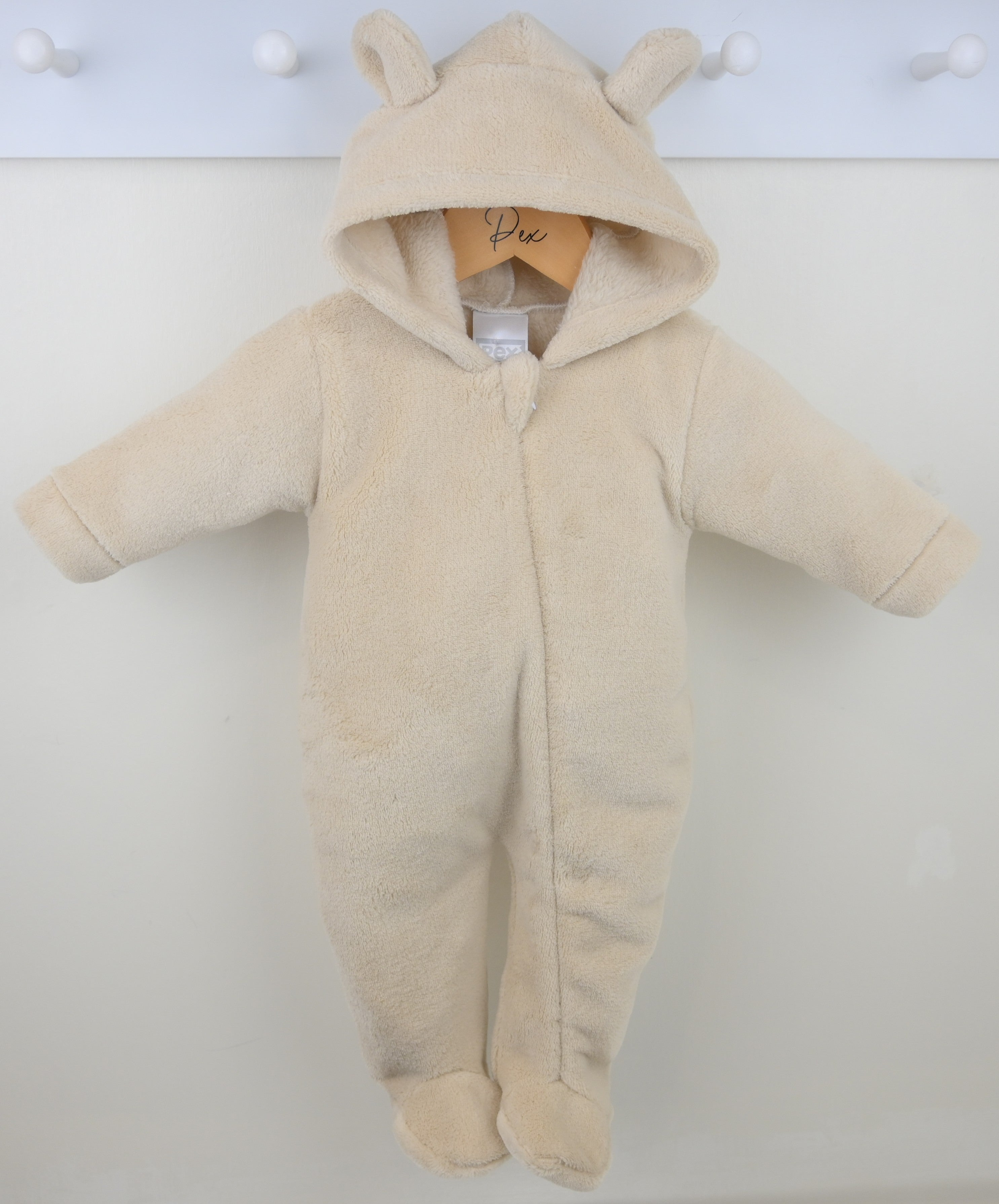 Beige baby snowsuit with bear ears on a white background